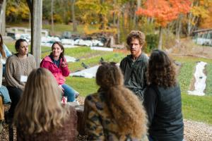 ABCs of Farm Based Education participants talk with gardener Josh Carter in outdoor pavilion