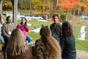 ABCs of Farm Based Education participants talk with gardener Josh Carter in outdoor pavilion