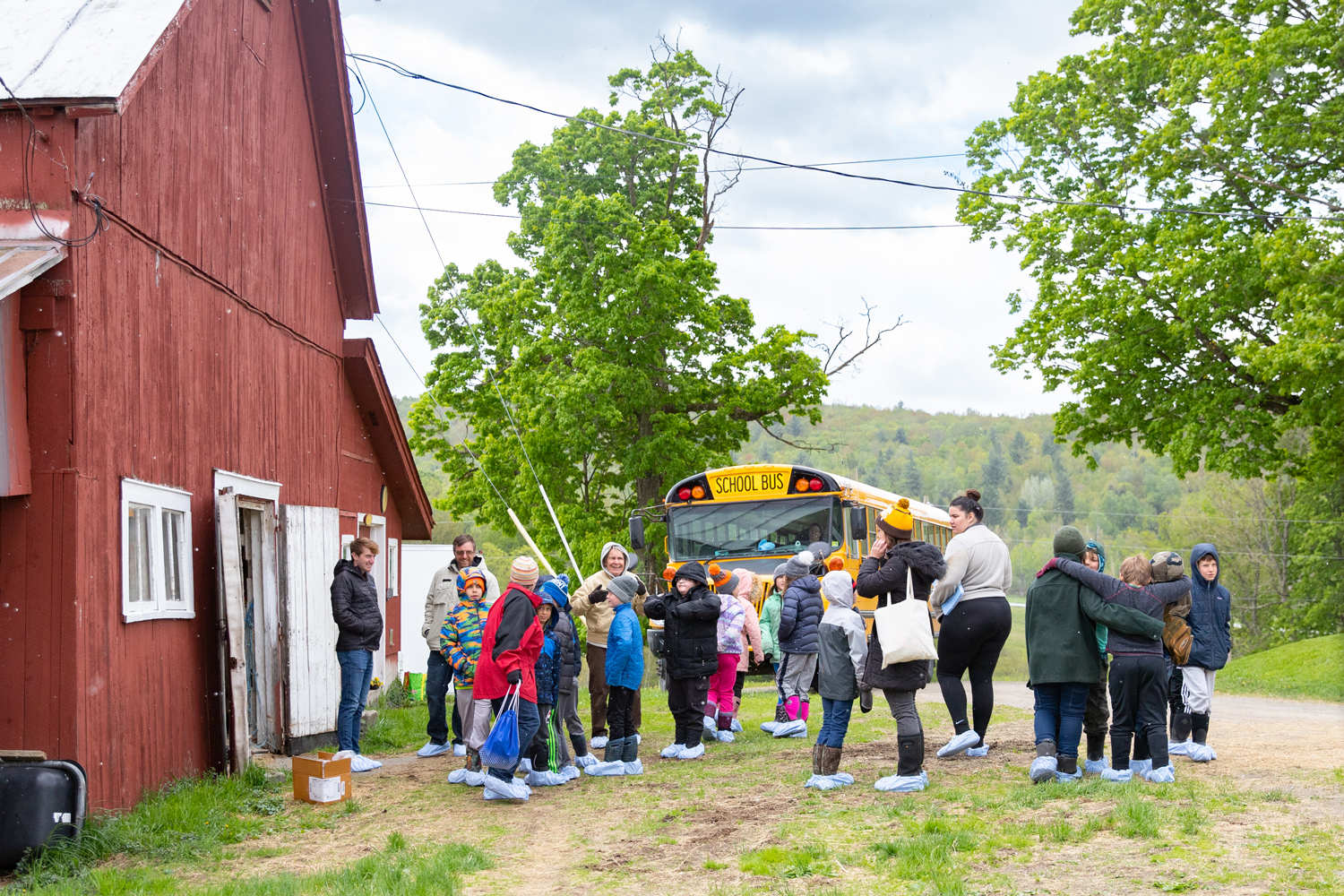 Cambridge Elementary students and their teachers circle up after their arrival to Paul-Lin Dairy in Bakersfield, VT.
