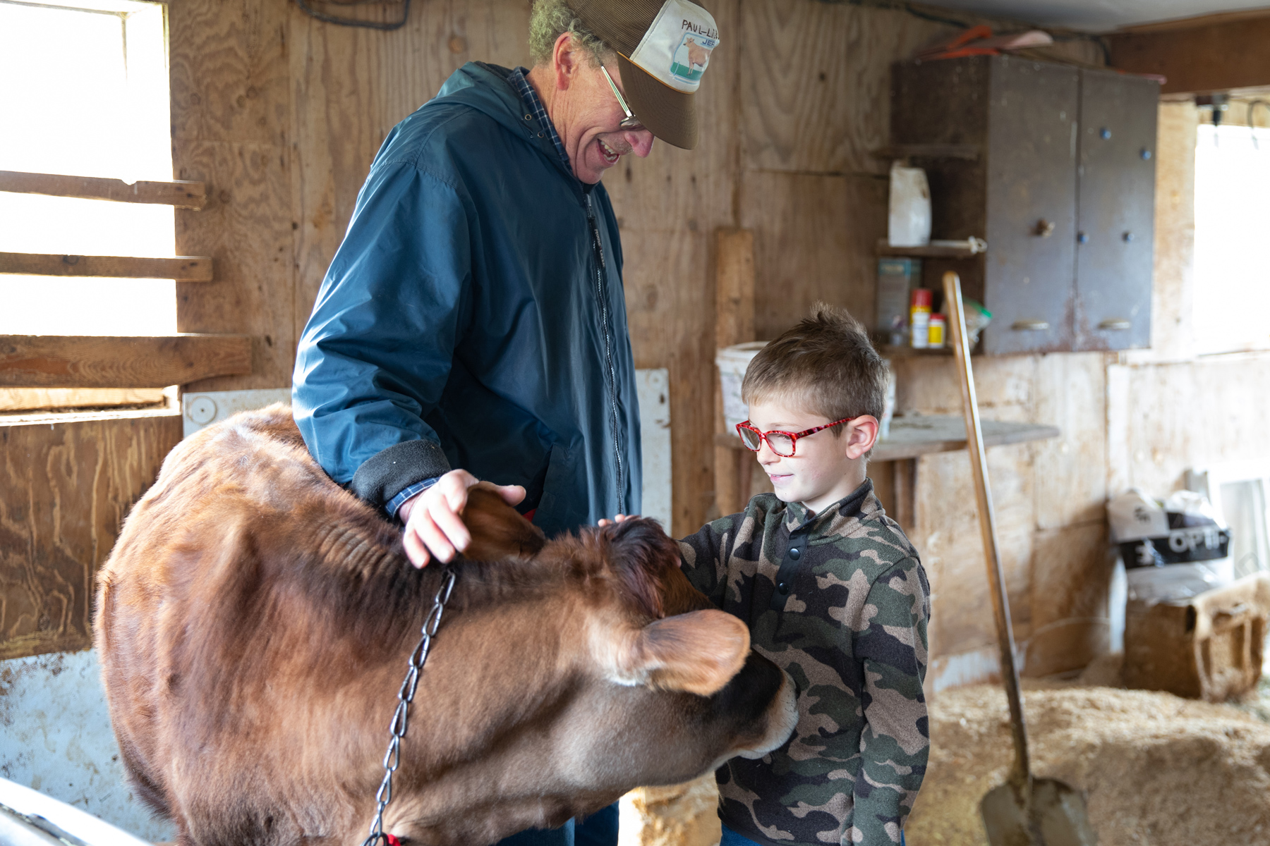 Farmer and Owner Paul Stanley leads students through the calf barn, teaching them about their diet and when they are weaned from milk.