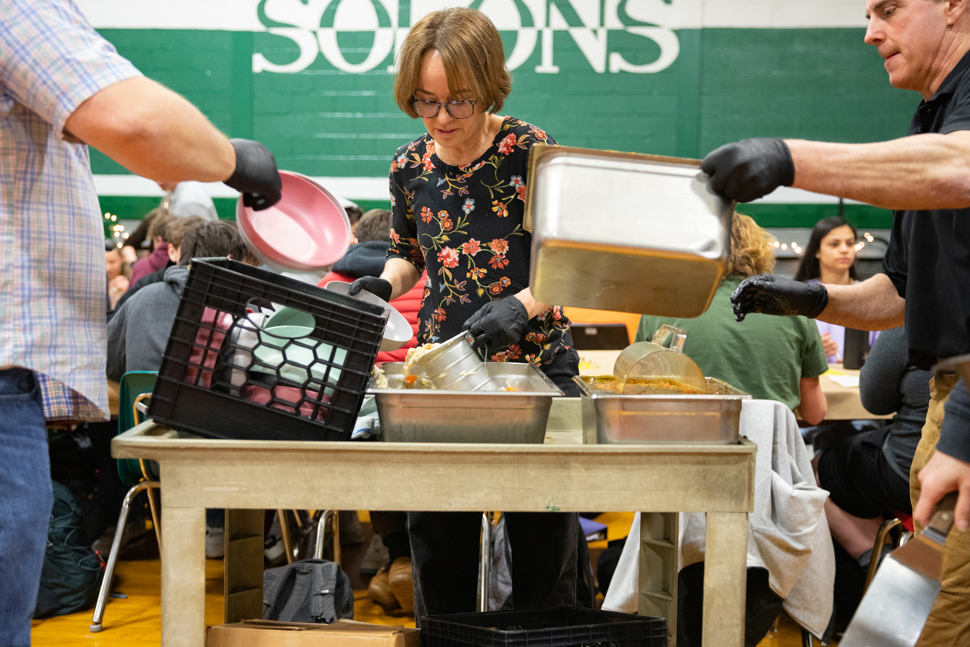 Teachers serve soup from a cart
