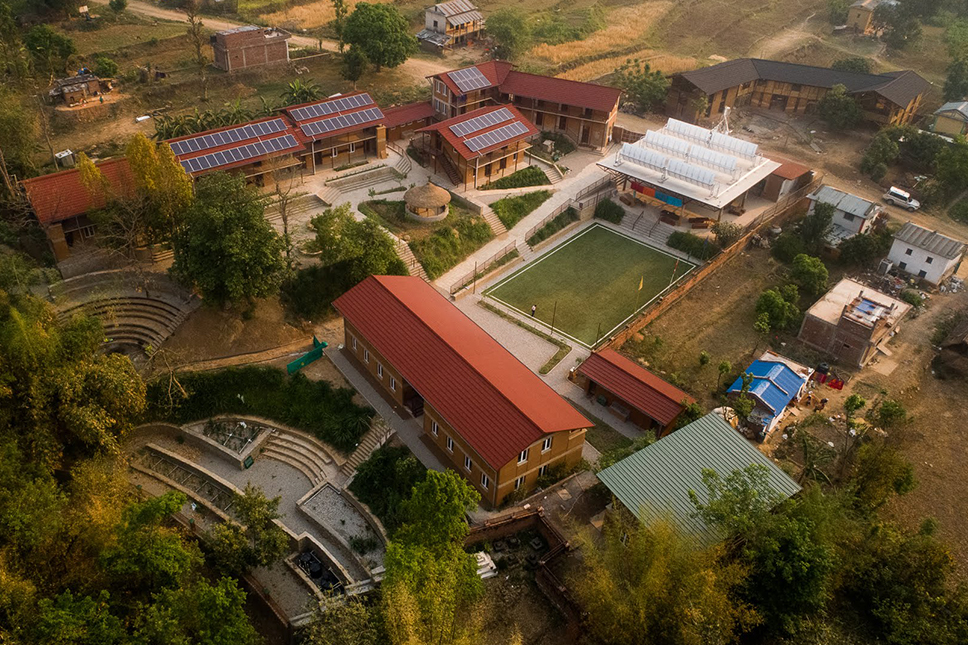 An aerial view of a school campus with several buildings and athletic fields