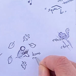 A closeup of a hand drawing leaves around a small figure