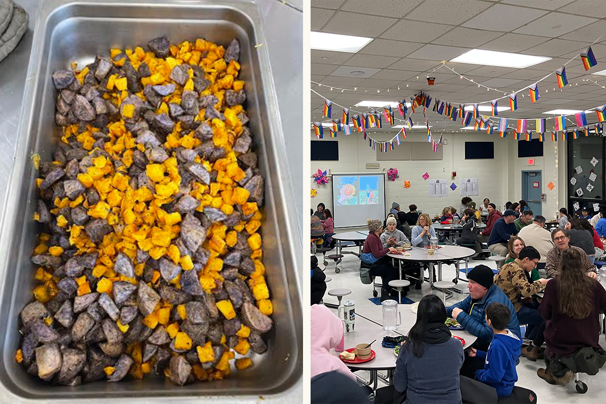 A tray filled with roasted chunks of purple and orange potatoes is on the left. On the right, the harvest dinner takes place in the cafeteria,  decorated with international flags. People seated at round tables, sharing a meal and conversing.