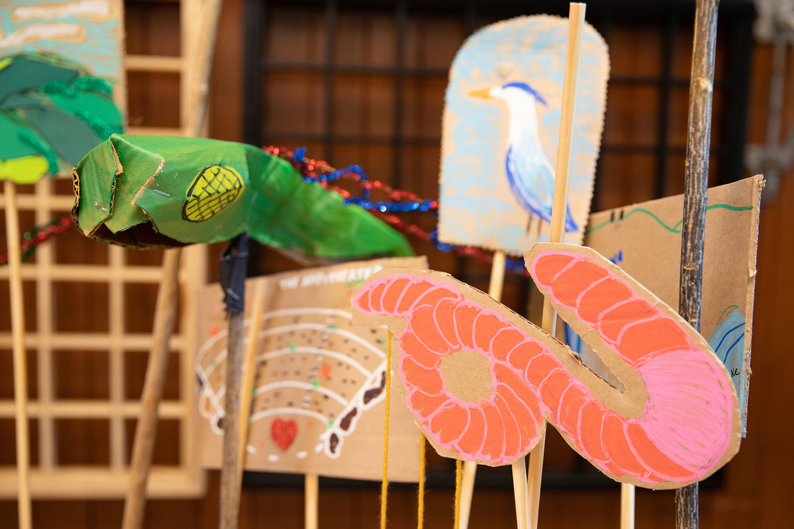 Paper mache puppets depicting animals stand on sticks