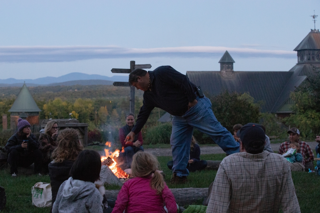 Chief Don Stevens feeds a fire during a Shelburne Farms campfire family program.