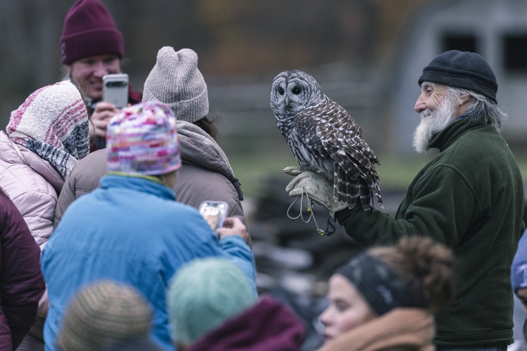 Craig with families holding an owl