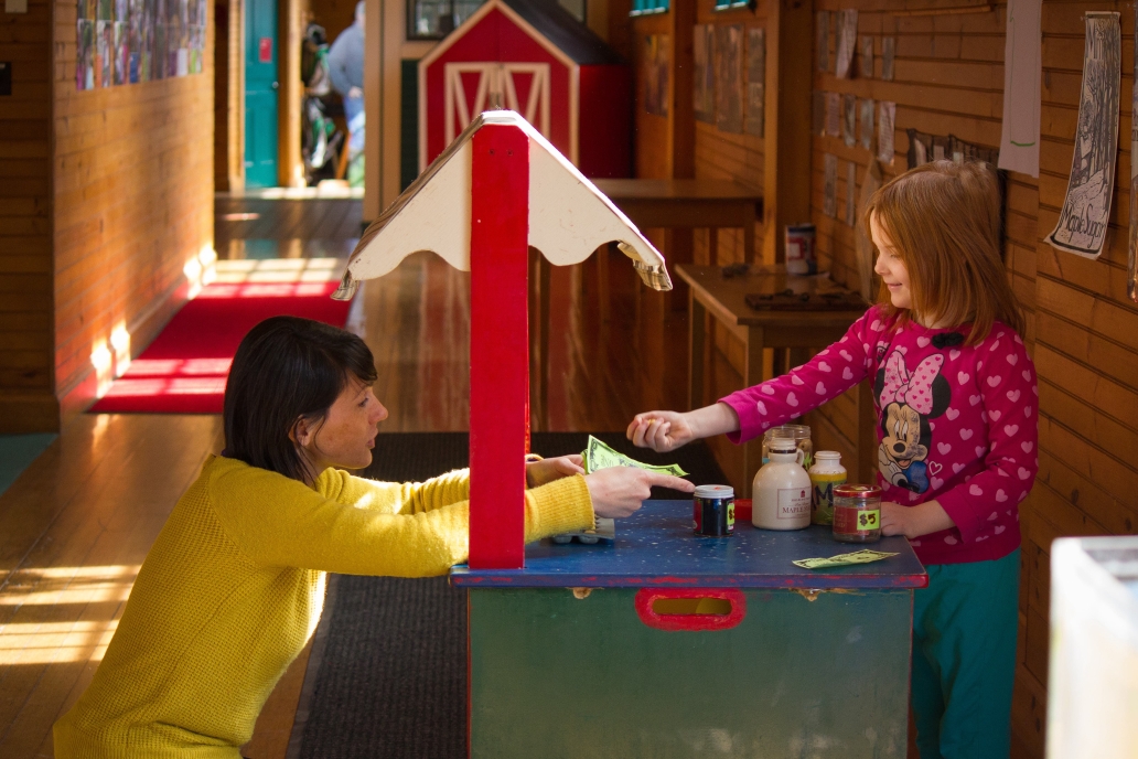 adult and child playing in ed center