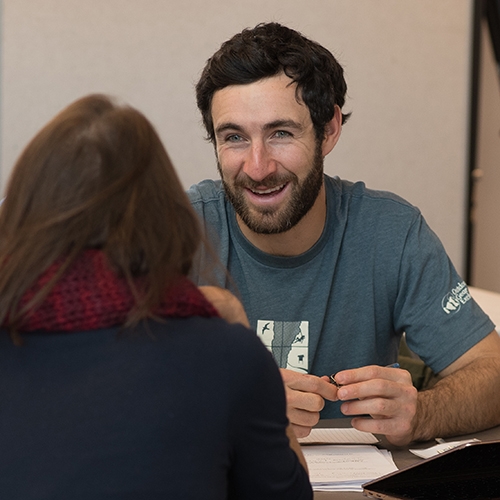 Participants in Shelburne Farms Climate Resiliency Fellowship talk around table