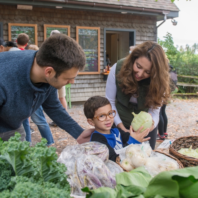 Family picking out produce from store