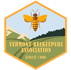 Hexagon shaped logo with text that reads "Vermont Beekeepers Association since 1886" over an illustration of a yellow bee rising over a mountainous landscape.