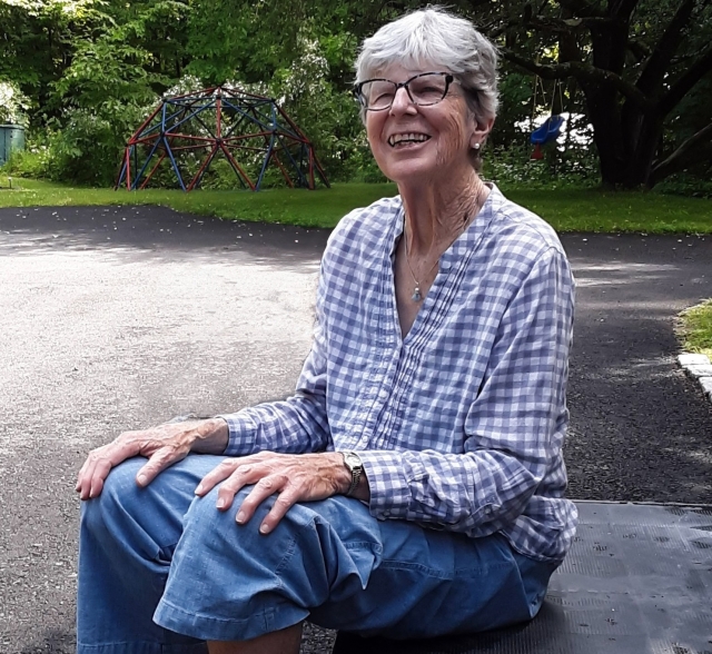 Anne Sullivan sitting outdoors