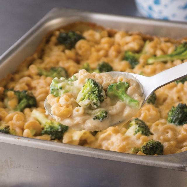 A deep pan on macaroni and cheese with broccoli