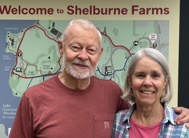 portrait: man with short gray beard and hair with arm around woman with chin-length gray hair and in a flannel shirt