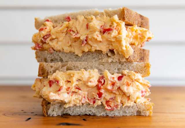 Two halves of a pimento cheese sandwich, stacked on top of one another