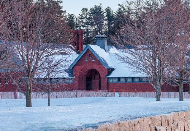 brick coach barn in snow