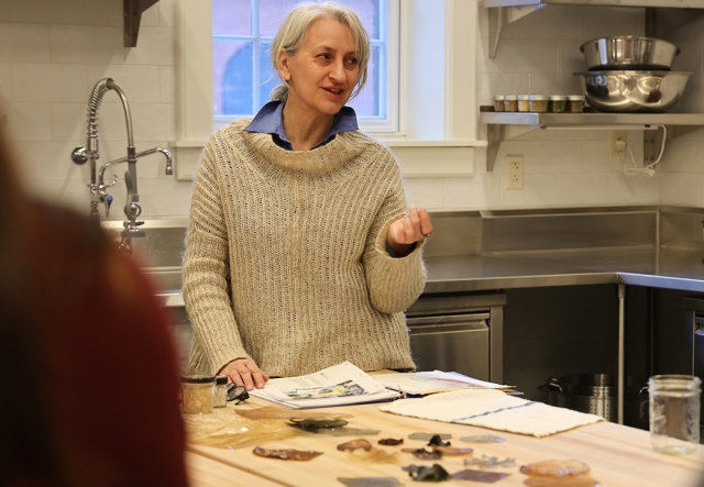 Educator Muriel Stallworth smiles while talking in an industrial kitchen