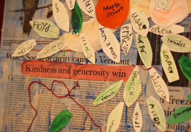 A collage artwork with cut paper pieces over newspaper that reads kindness and generosity win