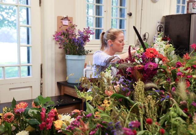 woman in ponytail arranging flowers