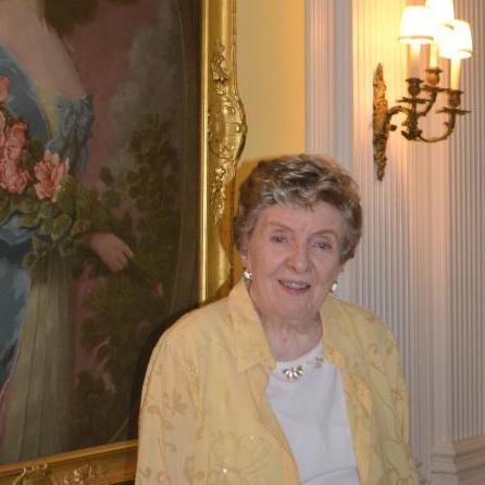 Shirley Murray in front of a portrait of Lila Webb in the Tea Room at the Shelburne Farms Inn, 2017