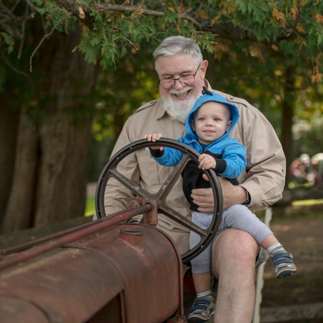 Grandfather and grandson sitting on a tractor