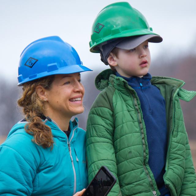 woman with young boy in hard hats