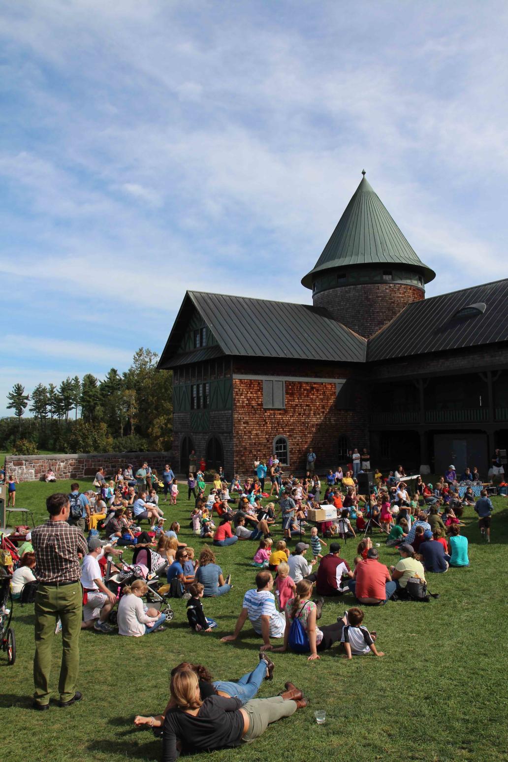 The Farm Barn Courtyard, filled with people watching a concert.