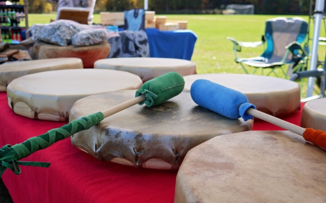 A set of drums resting on a table in an outdoor setting.