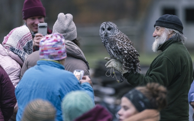 Craig with families holding an owl