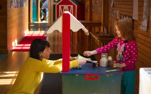 adult and child playing in ed center