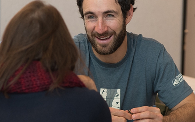 Participants in Shelburne Farms Climate Resiliency Fellowship talk around table
