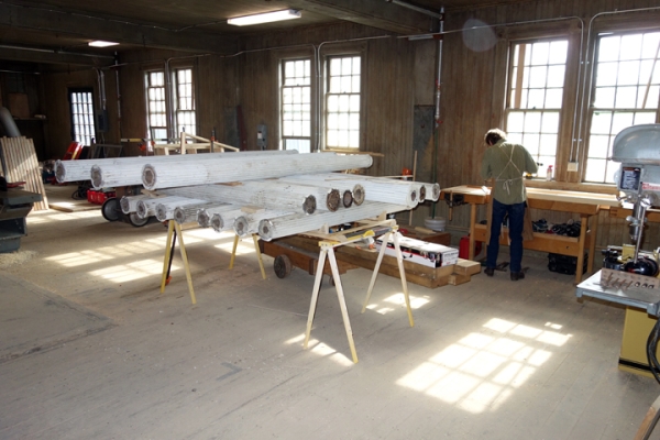 In the Breeding Barn, Doug Porter works on restoring the south pergola's columns. (Angelyn Bass)