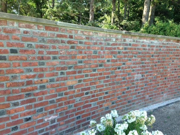Northern pergola wall after repointing. Note the Flemish bond brick coursing pattern, which alternates short and long bricks (headers and stretchers). The dark bricks were glazed and fired to achieve the black color. (Julie Eldridge Edwards)