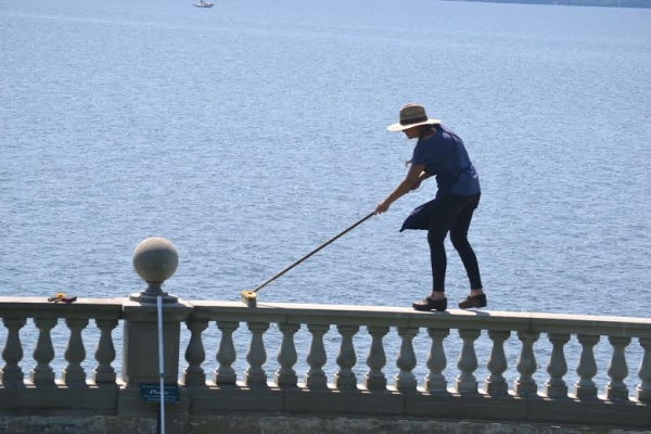 Conservator Angelyn Bass cleaning the wall caps of the overlook balustrade. Note: Do not try this at home (or here)! (Janice Heilmann)