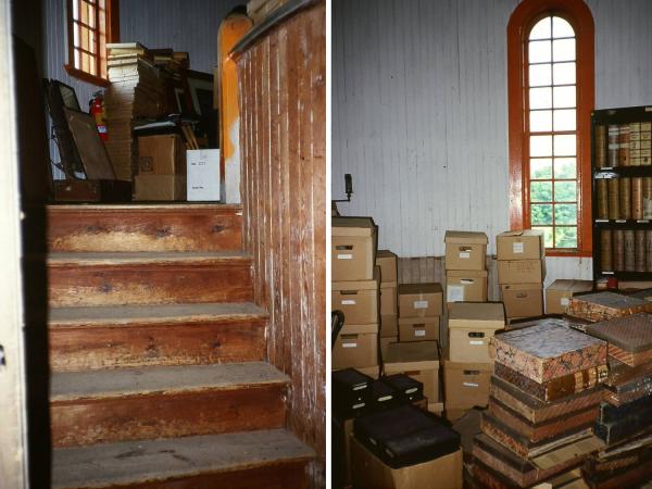 stairs leading to turret of Farm Barn filled with cardboard boxes and books.