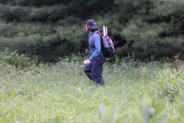 Lourenco Martins in the field. We use stopwatches to time the flashes of the fireflies, which helps to identify species. We also use long collapsible nets to catch the fireflies after we've timed them.
