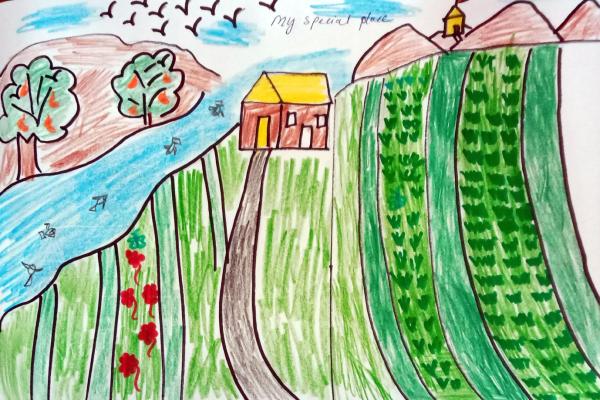 A drawing by a student in Xplorers Without Borders Camp. The illustration is in colorful marker of fields in front of a house and reads, My Special Place.