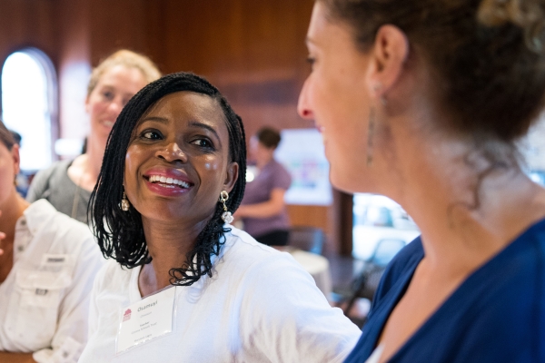 Two educators smile in discussion at a Shelburne Farms professional learning program