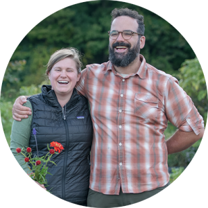 Shelburne Farms educator Simon Schreier smiles with partner in farm garden