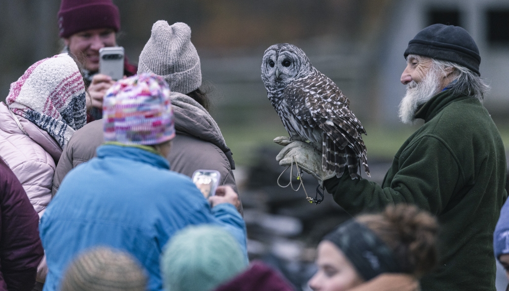 Craig with families holding an owl