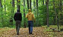two people walking in woods