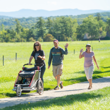 3 people enjoying the trails with a stroller