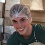 Perry Willett smiling in a hairnet in the cheesemaking facilities.